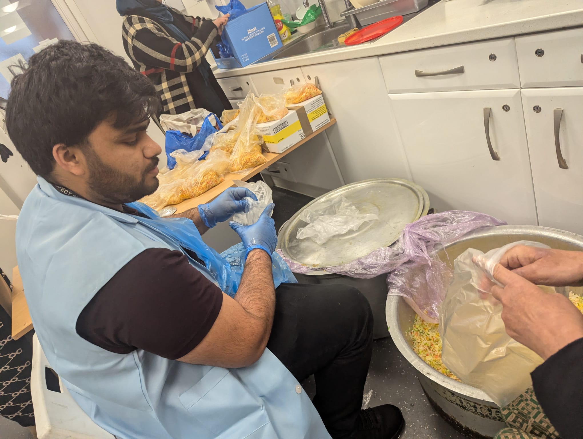 A volunteer packing food parcels for local families